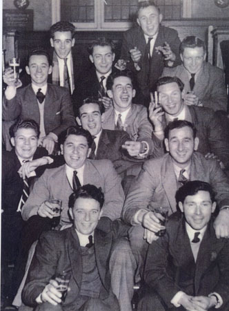 Copy of a photograph taken at the Russell Hotel, Russell Square, London during a rugby international at Twickenham 1956/8. Left to right from the back Derek John, Brian John, Gareth Morgan, Dawson Jones, Sidney Thomas, John Davies, Dilwyn Lewis, Teddy Sinnett, Malcolm Rowlands (Hook), Donald John, Johnny Davies, Billy Hitchins, Donald Rees